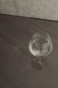 Kaboompics - Empty Faceted Wine Glass on a Charcoal Tabletop