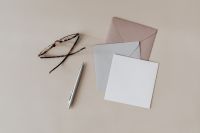 Kaboompics - Blank Invitation Mockup with Tortoiseshell Glasses, Silver Pen and Envelopes