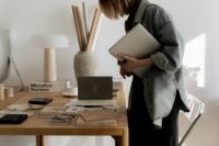 Kaboompics - Designer with Laptop Reviewing Material Swatches at Sunlit Studio Table