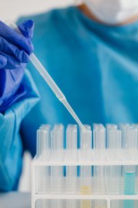 Kaboompics - Close-Up of Gloved Hand Holding Laboratory Pipette