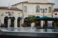 Kaboompics - Designer Outlet Courtyard with Fountain and Green Umbrellas