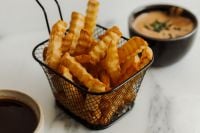 Kaboompics - Crinkle Cut Fries in Wire Basket with Dipping Sauce
