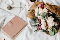 Kaboompics - Flower Bouquet With Pink Notebook and Tea on White Sheets