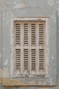 Kaboompics - Peeling Blue-Gray Plaster Wall with Old Louvered Shutters