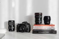Kaboompics - Photographer's desk - books, DSLR camera and lenses