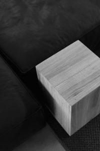 Kaboompics - Black Leather Sofa and Wooden Cube Table, Tight Minimalist Interior Crop