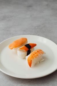 Kaboompics - Three-Piece Nigiri Sushi on White Plate with Gray Copy Space