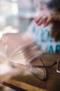 Kaboompics - Close-Up of Open Book Eyeglasses and Smartphone on Cafe Table