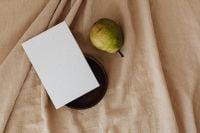 Kaboompics - Overhead Pear and Business Card Mockup on a Wooden Plate and Linen