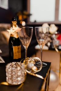Kaboompics - Champagne Bottle and Two Glitter-Dotted Flutes with Gold Ornament