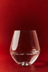 Kaboompics - Rounded Wine Glass on Red Background