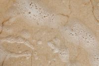 Kaboompics - Soap Suds on a Beige Stone Surface
