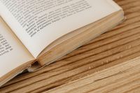 Kaboompics - Open Book Resting on Wood for Warm Reading, Publishing and Editorial Backgrounds