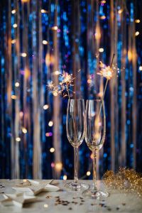 Kaboompics - Close-Up Champagne Flutes and Sparkler Stems on a Navy Blue Background