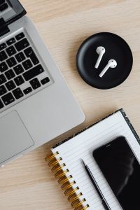 Kaboompics - Top View of Laptop, AirPods, Smartphone and Notebook with Pen