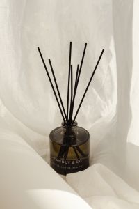 Kaboompics - Black Reed Diffuser Sticks in a Linen Texture Close-Up