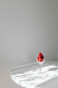 Kaboompics - Small Raspberry Glass On Round Marble Table