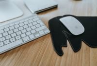 Kaboompics - Macro Office Desk Detail of White Apple Mouse and Keyboard on Elephant-Shaped Mouse Pad