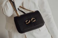 Kaboompics - Close-Up of Black Ribbed Handbag with Chunky Gold Chain Clasp