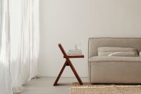 Kaboompics - Gray Sofa and Wooden Stool with Books and Water Glass in Neutral Interior