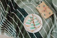 Kaboompics - Iced Christmas Cookies and Wrapped Gift on Green Throw