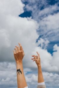 Kaboompics - Two Hands Reaching into a Blue Cloudy Sky, Swallow Tattoo and Freedom Concept