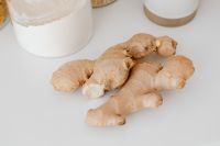 Kaboompics - Fresh Ginger Root Pieces on a White Kitchen Counter with Pantry Jars