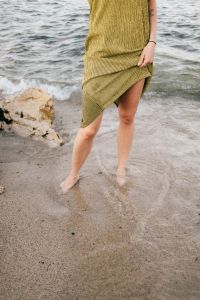 Kaboompics - Green Textured Summer Dress beside Sea Foam, Coastal Fashion Detail for Travel Design