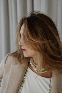 Kaboompics - Side Portrait with Hair Across Her Face and Layered Pearl Necklaces