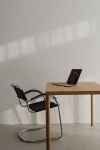 Kaboompics - Minimalist Wooden Desk And Laptop With Empty Chair
