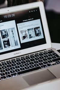 White laptop on a table with a remote
