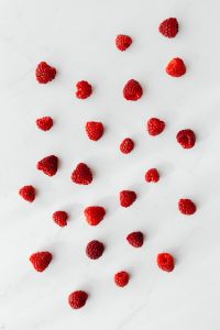 Kaboompics - Scattered Raspberries On White Marble Background