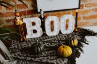 Kaboompics - Illuminated BOO Sign with Mini Pumpkins and Halloween Figurines