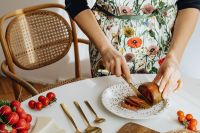 Kaboompics - Hands Slicing Produce on a White Plate