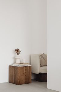 Kaboompics - Minimalist Room Corner with Walnut Side Table, Armchair and Large Wall Copy Space