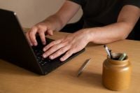 Kaboompics - Man Typing on a Laptop with Desk Accessories