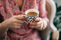 Kaboompics - Woman in pink holding a coffee