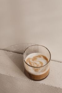 Kaboompics - Minimal Glass Coffee on a Concrete Block Against a Warm Beige Wall