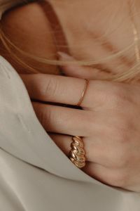 Kaboompics - Gold Ring on Woman's Hand Against Open Silk Shirt