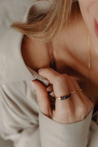 Kaboompics - Woman Adjusting Tan Silk Shirt Wearing Gold Ring