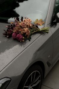 Kaboompics - Moody Flower Bouquet on a Wet Car