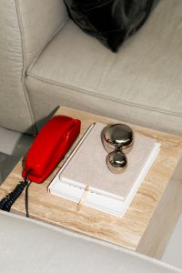 Kaboompics - Vintage Red Telephone On Marble Side Table With Books