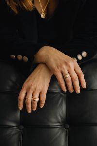 Kaboompics - Woman's Hands with Gold Rings on Black Leather Sofa