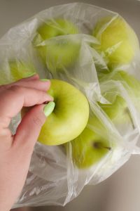 Kaboompics - Hand Picking a Green Apple from a Grocery Bag