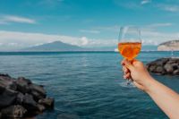 Kaboompics - Aperol Spritz above a Rocky Mediterranean Coastline