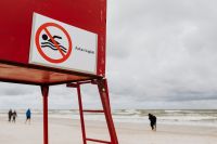 Kaboompics - No-Swimming Sign on a Red Lifeguard Station with Open Sky for Beach Safety Design