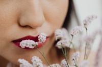 Kaboompics - Asian Woman Close-Up with Red Lipstick and Pink Flowers Near Her Face