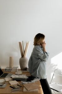 Kaboompics - Designer on Phone with Copy Space in a Minimal Creative Studio