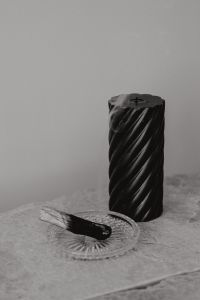 Kaboompics - Unlit Black Candle with Palo Santo Stick on Glass Dish, Neutral Marble Still Life
