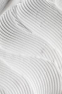 Kaboompics - Concentric Ridges in White Skincare Cream Forming a Curved Ripple Macro
